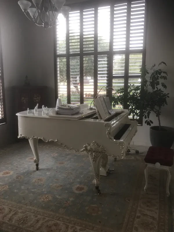 White grand piano in a bright room